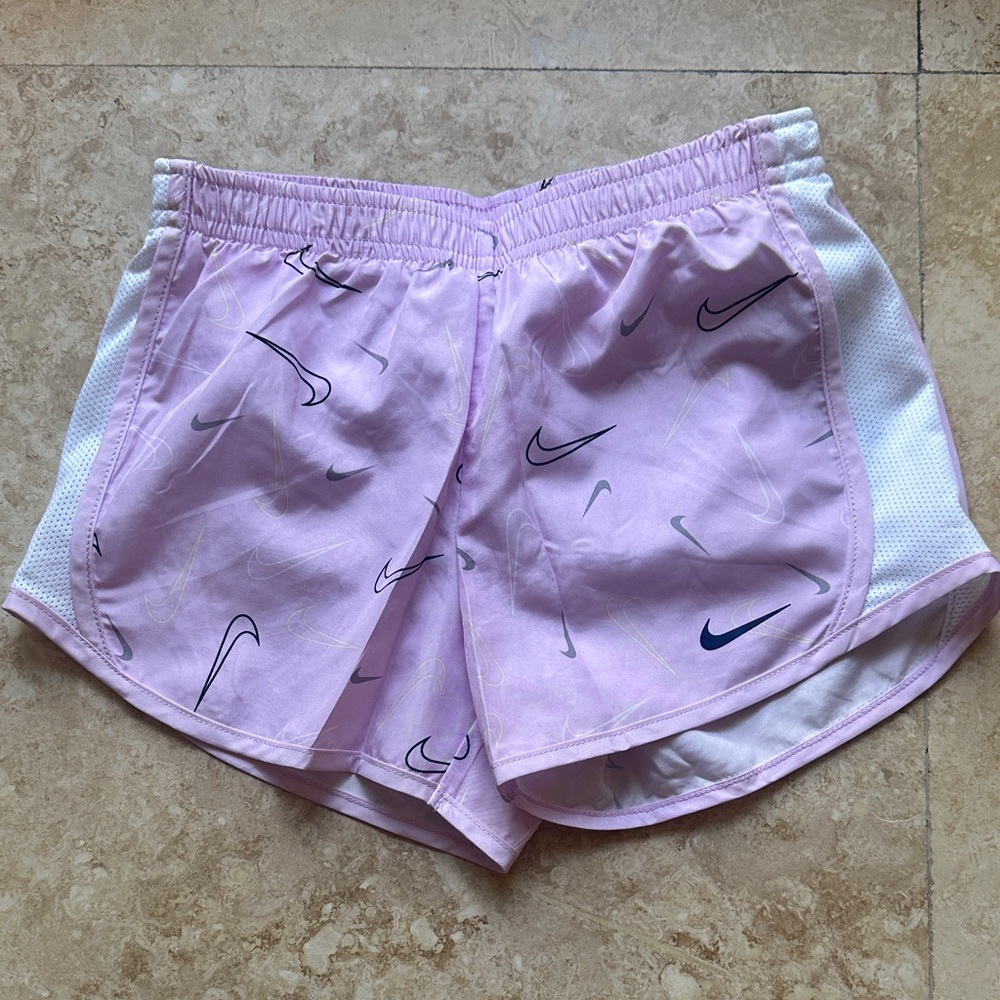 Nike Women's Light Pink Athletic Shorts with Swoosh Design